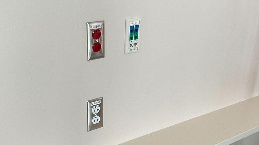 Photo of electrical receptacles in a hospital with the ground pin oriented up.