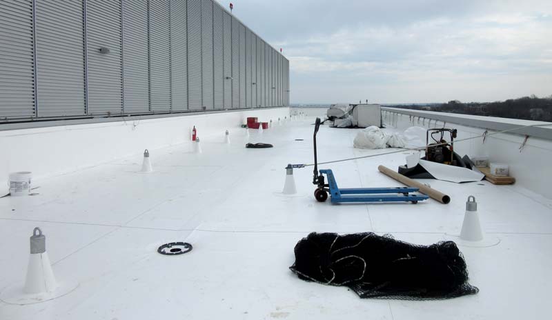 Photo of a Single-Ply Membrane Installation In Progress on a Flat Roof